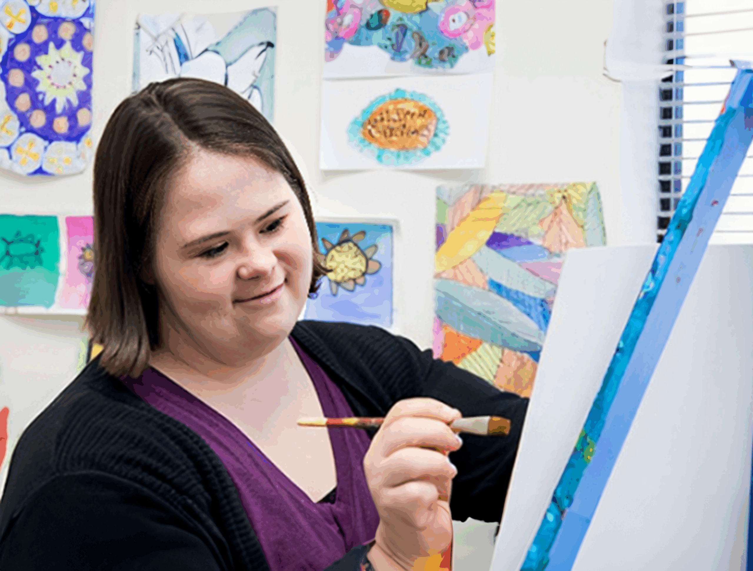 A Woman Stands With a Paintbrush